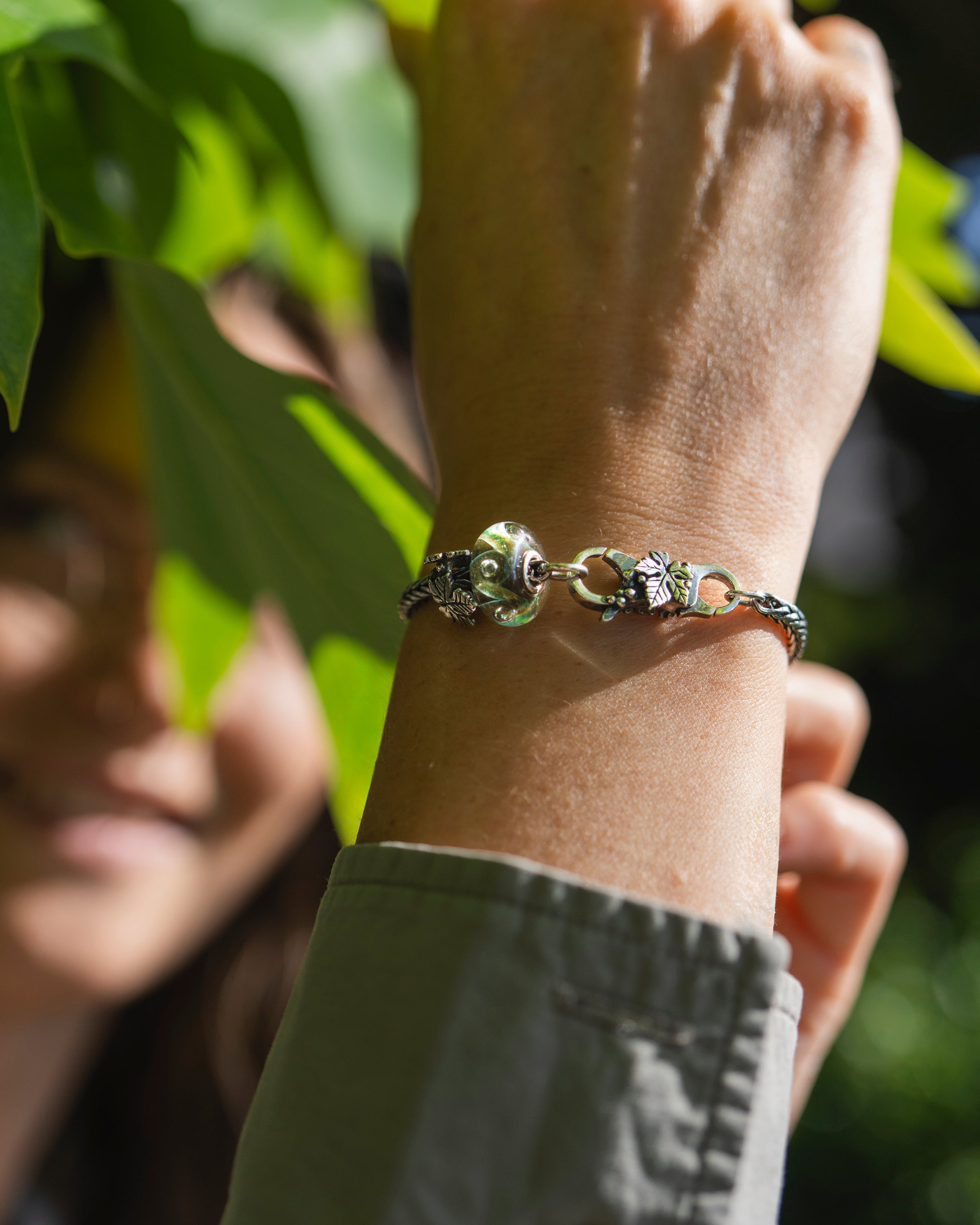 Close-up of a wrist wearing a bracelet with a blurred background